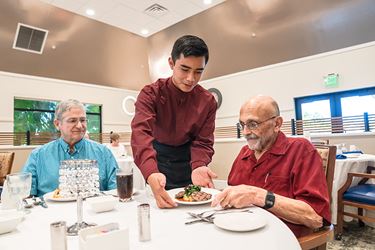 Friends Being Served A Fine Meal At The On Campus Restaurant