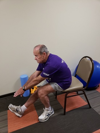 sitting hamstring and lower back stretch senior exercise