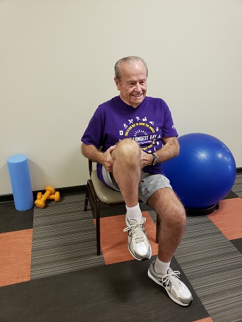 sitting knee to chest stretch senior exercise